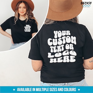 May include: Black t-shirt with white text that says "YOUR CUSTOM TEXT OR LOGO HERE" in a retro, groovy font.