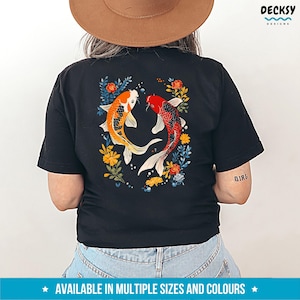 May include: Black t-shirt featuring a graphic of two koi fish swimming in a floral design. The fish are red, orange, and white. The flowers are blue, yellow, and green.