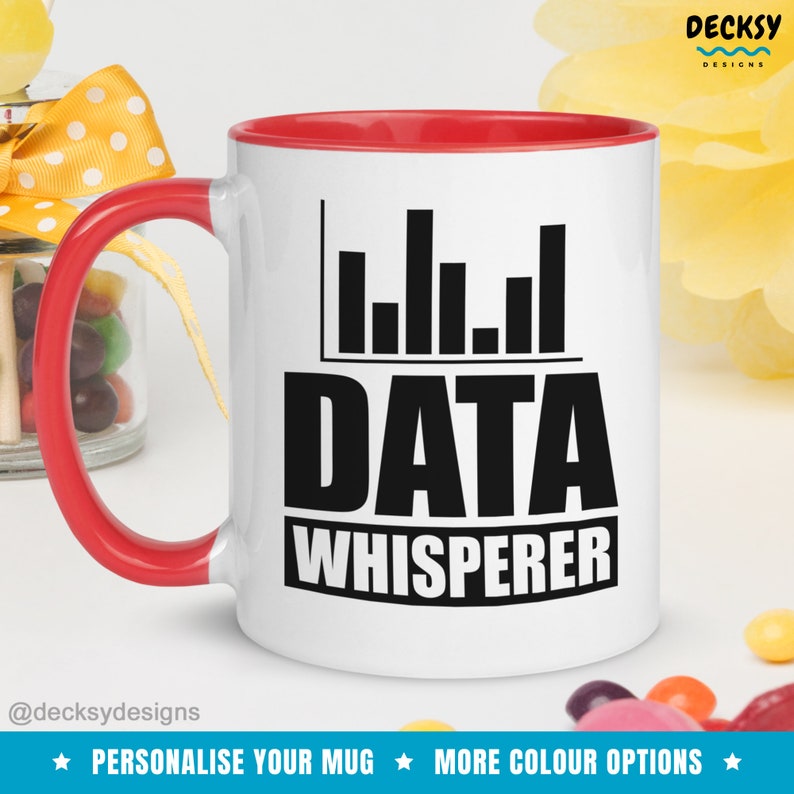 May include: White ceramic mug with a red rim and handle. The mug features a black graphic of a bar chart and the text "DATA WHISPERER".
