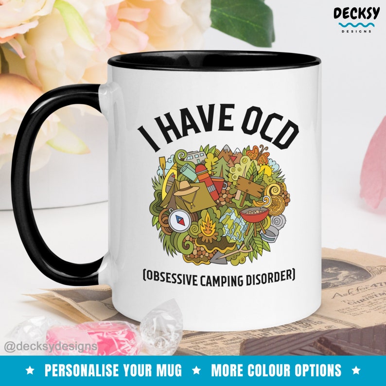 May include: White ceramic mug with a black rim and handle. The mug has a black and white graphic of camping equipment and the text "I HAVE OCD (OBSESSIVE CAMPING DISORDER)".