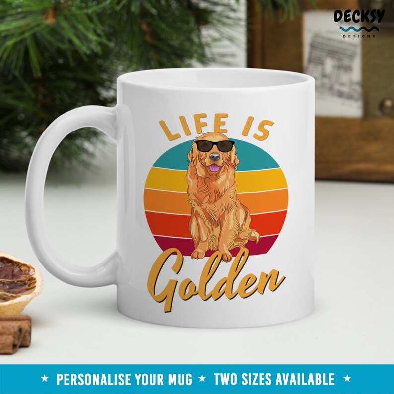 May include: White ceramic mug with a golden retriever wearing sunglasses and the text "Life is Golden" in a retro-style font. The background is a colorful sunset.