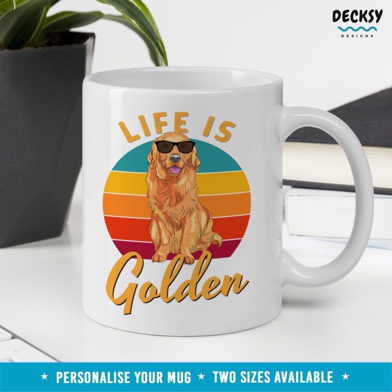 May include: White ceramic mug with a retro sunset design and a golden retriever wearing sunglasses. The text "Life is Golden" is printed on the mug.