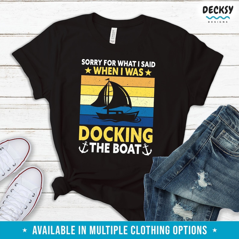 May include: Black t-shirt with a vintage sunset graphic of a sailboat and the text "Sorry for what I said when I was docking the boat".