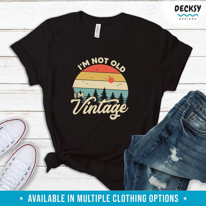 May include: Black t-shirt with a vintage sunset graphic and the text "I'm not old, I'm vintage".