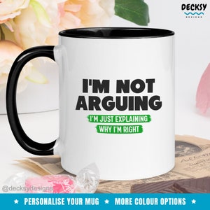 May include: White coffee mug with a black rim and handle. The mug has black text that reads "I'm not arguing I'm just explaining why I'm right" with green text underneath.