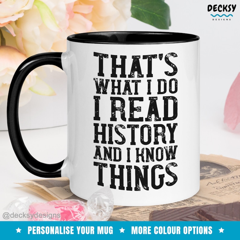 May include: White ceramic mug with a black rim and handle. The mug has black text that reads "That's what I do I read history and I know things".