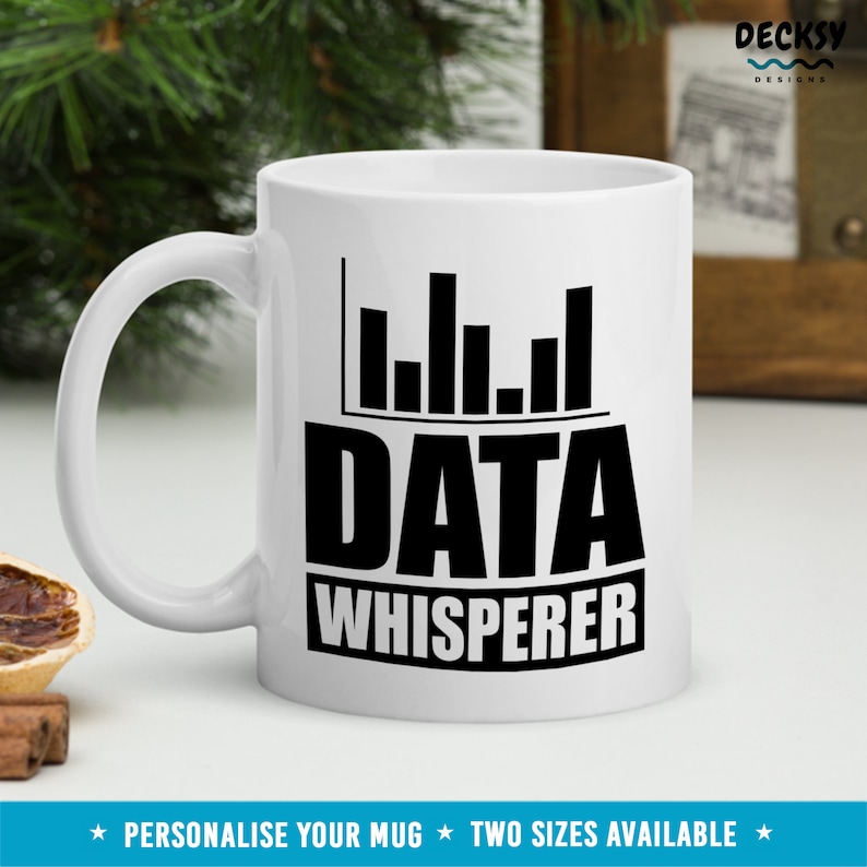 May include: White ceramic mug with a black graphic of a bar chart and the text "DATA WHISPERER".