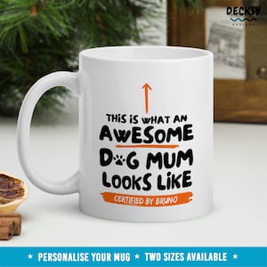 May include: White ceramic mug with a black and orange design. The text reads "This is what an awesome dog mum looks like. Certified by Bruno."