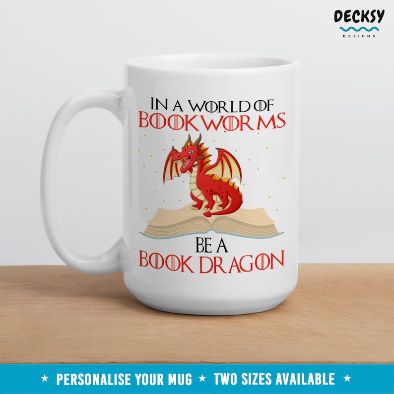 May include: White ceramic mug with a red dragon sitting on an open book. The mug has the text "In a world of book worms be a book dragon" printed on it.