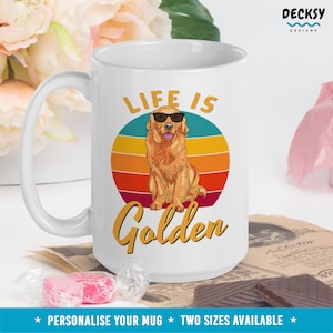 May include: White ceramic mug with a golden retriever wearing sunglasses in front of a retro sunset design. The text "Life is Golden" is printed on the mug.