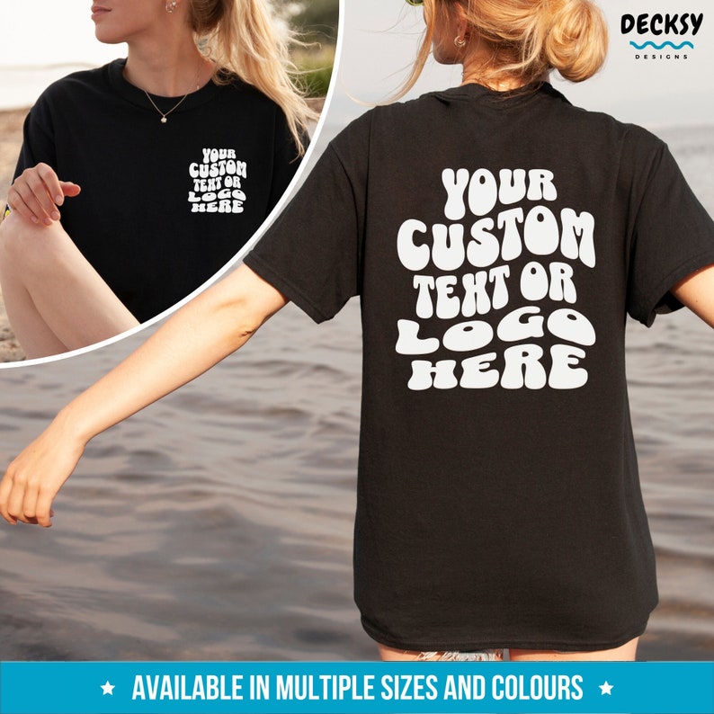May include: Black t-shirt with white text that says "YOUR CUSTOM TEXT OR LOGO HERE" in a retro font style. The text is centered on the back of the shirt.