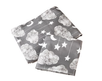 May include: Grey bedding set featuring a white cloud and star design. The set includes a flat sheet, fitted sheet, and pillowcase.