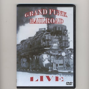 May include: A DVD cover featuring a black and white photo of a large steam locomotive with the text "GRAND FUNK RAILROAD LIVE" in red letters. The DVD logo is in the bottom right corner.