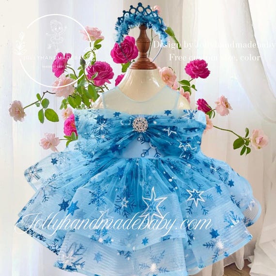 snowflake fairy dress The Snowflake Dress sparkles like winter magic shimmering white and icy blue layers that twirl like falling snow. Glittering accents catch the light with every move, making it perfect for festive