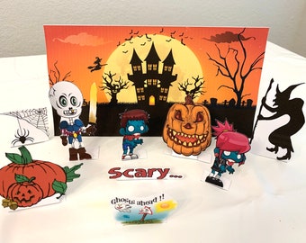May include: A Halloween-themed scene with paper cutouts of a skeleton, a zombie, a pumpkin, a witch, and a spider web. The scene includes the text "Scary..." and "Ghosts ahead!"
