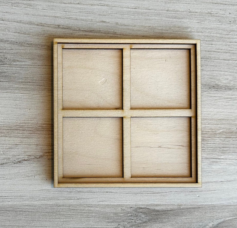 May include: A wooden tray with four square compartments. The tray is made of light brown wood and has a natural finish.