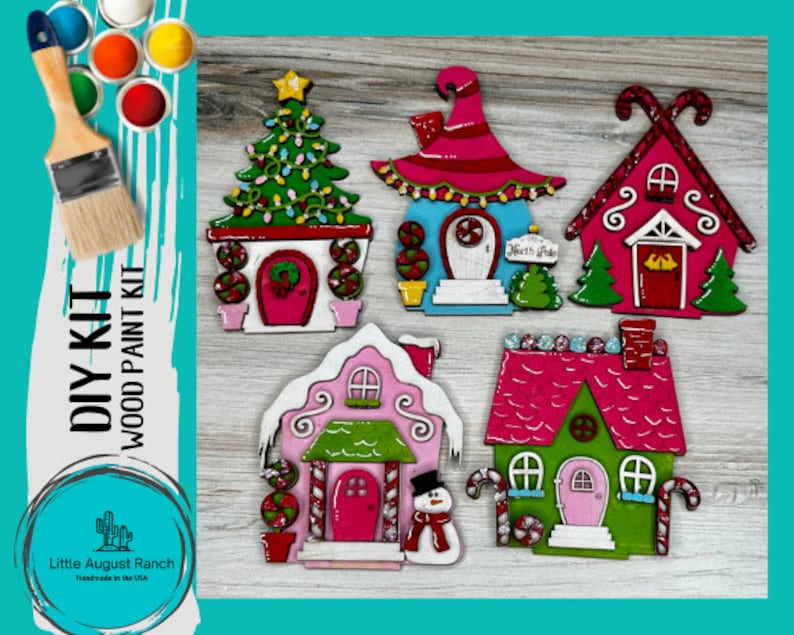 May include: A DIY wood paint kit featuring five unfinished wooden gingerbread houses with candy cane accents. The houses are decorated with red, pink, green, and blue paint. The kit includes a paintbrush and paint colors.