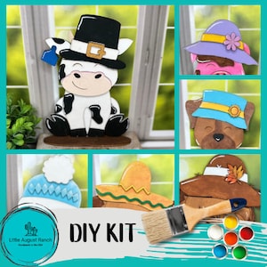 May include: DIY craft kit featuring five wooden animal figures with hats. The kit includes paint, a paintbrush, and the text "DIY KIT".