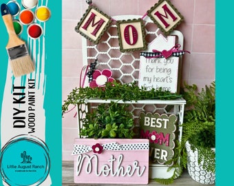 May include: DIY wood paint kit for Mother's Day. The kit includes a variety of wooden signs with the words "MOM", "Best Mom Ever", "Thank you for being my heart's first home", and "Mother".