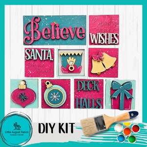 May include: DIY Christmas sign kit with eight wooden signs featuring festive sayings like "Believe", "Candy Cane Wishes", "Santa Defines Good", "Deck the Halls", and more. The kit includes paint and a brush.