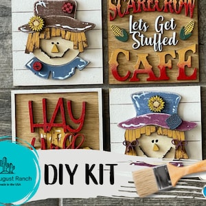 May include: DIY kit for a set of four wooden signs featuring scarecrows and fall-themed text. The signs are unfinished and ready to be painted. The kit includes a paintbrush and a set of acrylic paints.