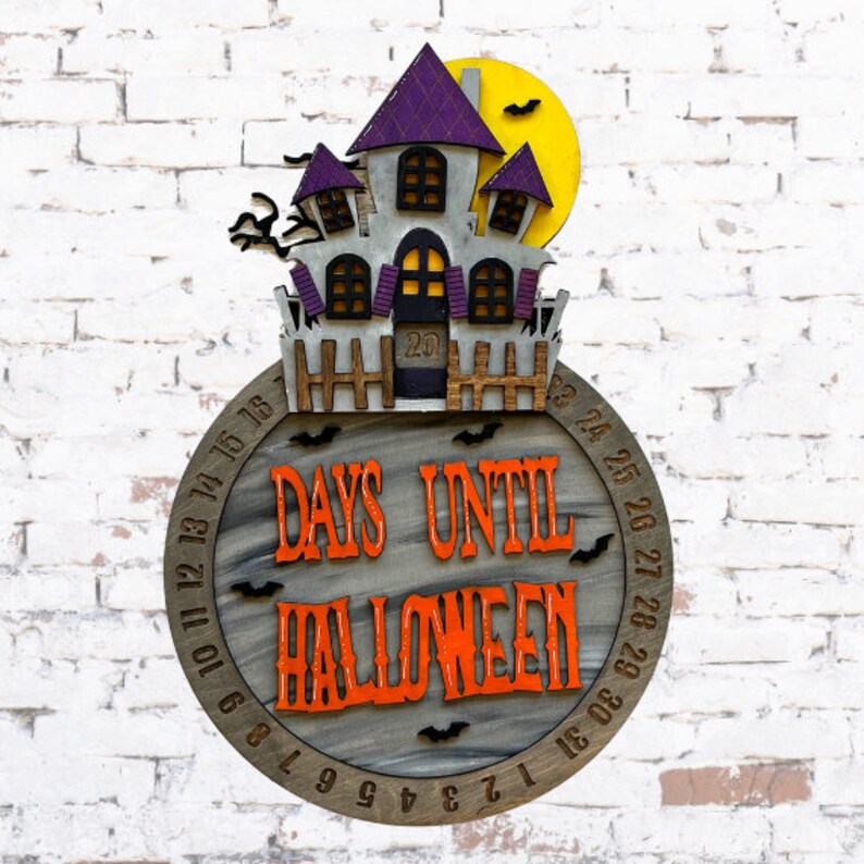 May include: A wooden Halloween countdown clock with a purple and gray haunted house design. The clock features the text "Days Until Halloween" and numbers 1 through 31 around the edge.