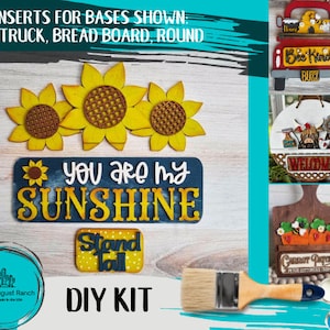 May include: DIY craft kit with wooden cutouts for a sunflower, truck, breadboard, and round sign. The kit includes paint, a paintbrush, and the text "You are my sunshine", "Stand Tall", "Bee Kind", "Welcome", and "Garden Patrol".