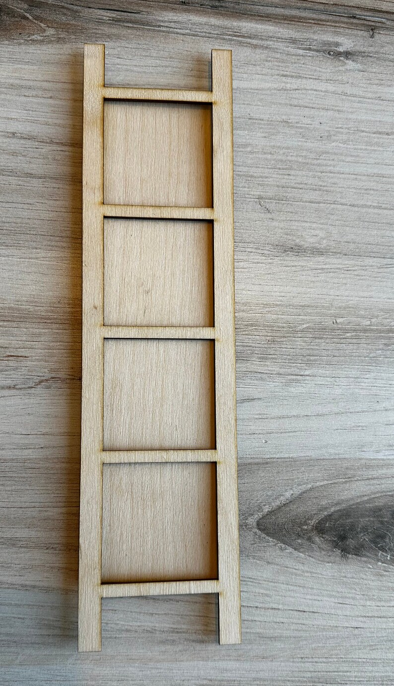 May include: A wooden shelf unit with four shelves. The shelf unit is made of light brown wood and has a simple design.
