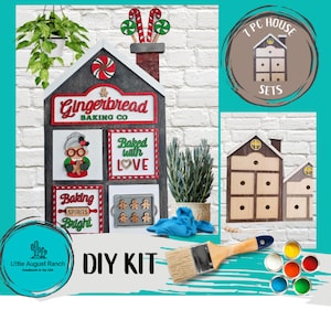 May include: DIY gingerbread house kit with 7 pieces, including a gingerbread house with a sign that says "Gingerbread Baking Co." and a gingerbread man, a gingerbread woman, a gingerbread cookie tray, and a sign that says "Baked with Love". The kit also includes paint and a paintbrush.