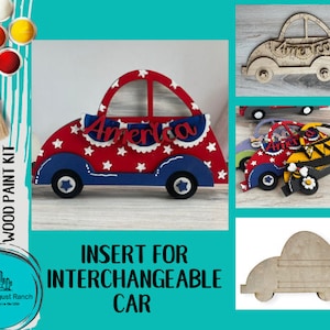 May include: DIY wood paint kit featuring a car-shaped insert with the word "America." The car is red, white, and blue, with star and banner details. The kit includes paint and a brush. The text "Little August Ranch" is also visible.