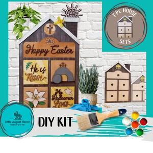 May include: DIY Easter house kit with a wooden house, paint, and brushes. The house has a sign that says "Happy Easter" and other religious sayings. The kit includes 7 pieces and is handmade in the USA.