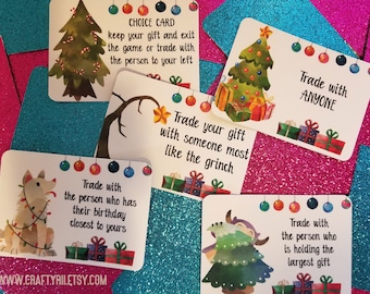 May include: A collection of Christmas-themed game cards with various instructions. Each card features festive illustrations of Christmas trees, gifts, and a dog with lights. Text on the cards includes phrases like "Trade with ANYONE" and "Trade with the person who has their birthday closest to yours."