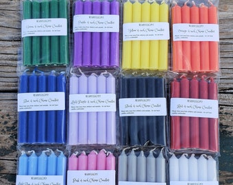 May include: A collection of twelve packs of 4-inch chime candles in various colors, including green, purple, yellow, orange, blue, light purple, black, red, light blue, pink, gray, and white. Each pack is sealed in a clear plastic bag with a label.