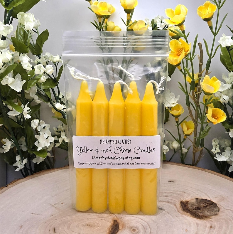 May include: A clear plastic bag containing five yellow chime candles with white wicks. A white label on the front reads: Metaphysical Gypsy, Yellow 4 inch Chime Candles, MetaphysicalGypsy.etsy.com, Keep away from children and animals and do not leave unattended.