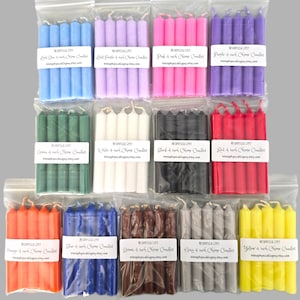 May include: Thirteen clear plastic bags each containing four 4-inch chime candles in various solid colors including light blue, light purple, pink, purple, green, white, black, red, orange, blue, brown, gray, and yellow with labels.