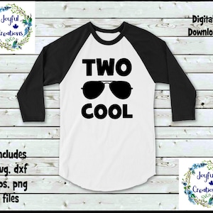 May include: A white and black baseball tee shirt with the text "TWO COOL" in black lettering and a pair of sunglasses graphic.