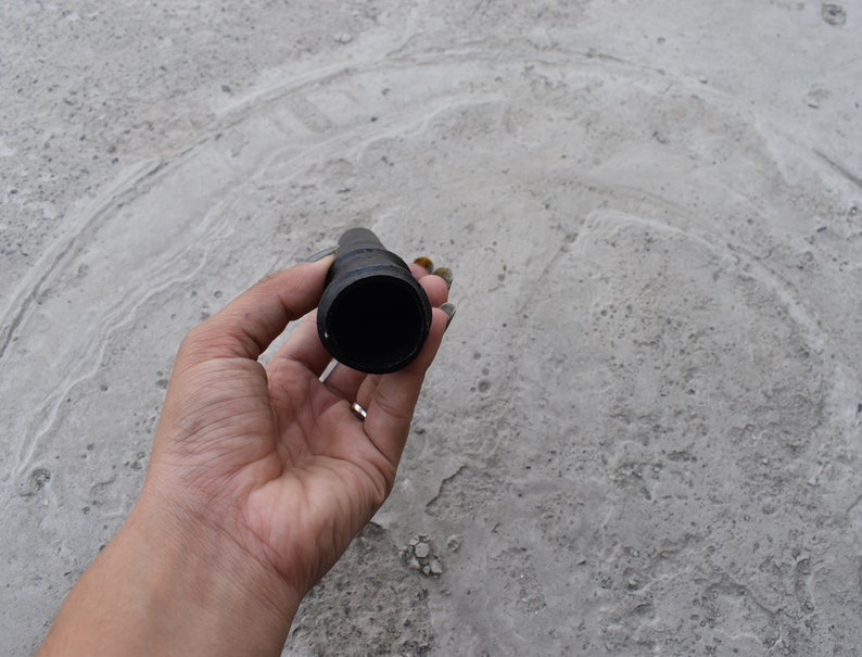 May include: A black rubber hose nozzle with a round opening.