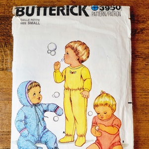 May include: A vintage sewing pattern for children's clothing. The pattern is for a small size and includes three different styles: a blue snowsuit, a yellow jumpsuit, and a pink onesie. The pattern is from Butterick and has the number 3950.