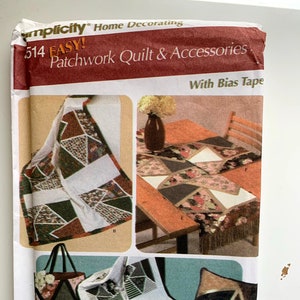 May include: A sewing pattern for a patchwork quilt and accessories. The pattern includes instructions for making a quilt, a table runner, a tote bag, a pillow, and a placemat. The pattern is by Simplicity and is called "Easy! Patchwork Quilt & Accessories with Bias Tape".