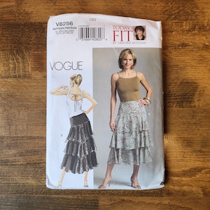 May include: A Vogue sewing pattern envelope V8256 for a tiered skirt. The front features the text Today's Fit by Sandra Betzina and displays illustrations and photographs of a person wearing a mid-length skirt with three tiers and a tank top.