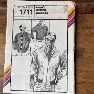 May include: A white paper sewing pattern envelope for Stretch & Sew 1711 action jackets, featuring illustrations of three jacket styles. The text includes 'STRETCH & SEW', '1711', 'action jackets', and 'Designed Exclusively for Knit Fabrics by Ann Person'.