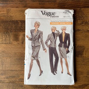 May include: A Vogue Patterns sewing pattern envelope, number 7340, featuring illustrations of three outfits including a plaid skirt suit, a plaid blazer with dark trousers, and a solid blazer with a plaid skirt. The text includes Vogue Patterns.