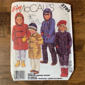 May include: An Easy McCall's 2785 sewing pattern envelope for children's jackets. The front features illustrations of four children wearing hooded toggle coats in red, yellow, blue, and dark purple, with text including the pattern number 2785.