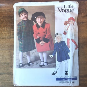 May include: A vintage sewing pattern for children's coats. The pattern is for sizes 2-6 and features three different styles: a plaid coat, a red coat with black trim, and a blue coat with buttons. The pattern is titled "Little Vogue" and has a sewing rating of "Easy/Facile".