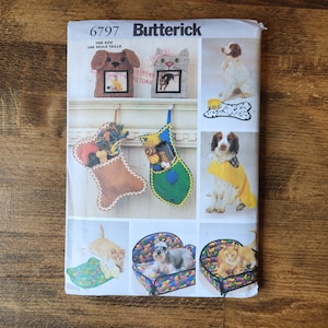 May include: A sewing pattern for making pet beds, toys, and accessories. The pattern includes instructions for making a dog bed, a cat bed, a dog stocking, a cat stocking, a dog bandana, and a dog bone mat. The pattern is from Butterick and the pattern number is 6797.