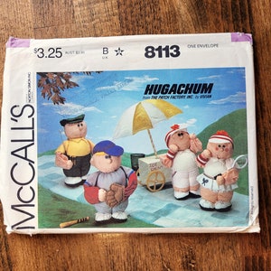 May include: McCall's sewing pattern envelope with a white background and a colourful illustration of four plush toys. The pattern is for making Hugachum toys from The Patch Factory Inc. by Vivian. The pattern number is 8113.