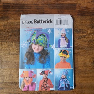 May include: A sewing pattern for making hats, featuring a variety of styles including a jester hat, a snowflake hat, and a beanie. The pattern is from Butterick and has the number B4306.