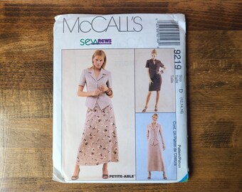 May include: A McCall's sewing pattern envelope featuring a woman in a skirt suit. The envelope has the McCall's logo and the text "sew news". The pattern includes a skirt suit with a floral print skirt and a short-sleeved jacket.