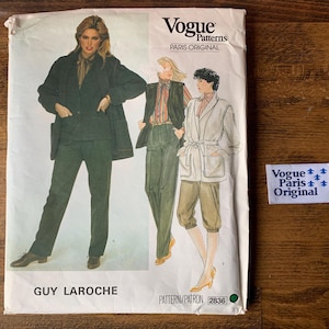 May include: Vogue Patterns sewing pattern featuring Guy Laroche designs. The cover shows illustrations of women's outfits, including a suit, vest and pants, and a belted jacket with shorts. The Vogue Paris Original label is visible.