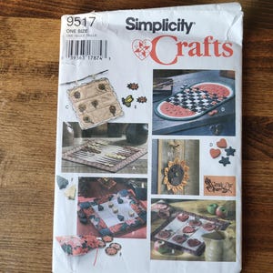 May include: A Simplicity Crafts sewing pattern for making various game boards. The pattern includes instructions for making a checkerboard, a watermelon-shaped game board, a noughts and crosses board, and a small square game board. The pattern number is 9517.
